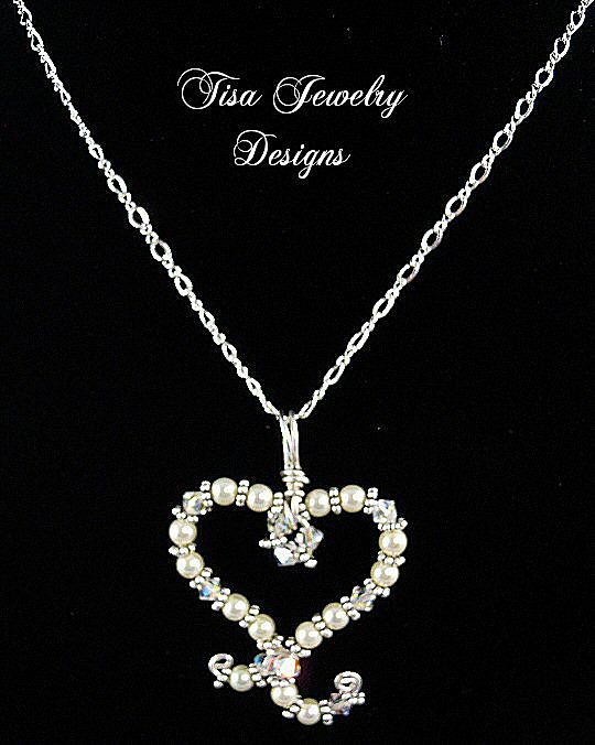 SWIRLED HEART PENDANT – Swarovski Crystals and crystal pearls hand-formed into a swirled heart design SWIRLED HEART PENDANT – Swarovski Crystals and crystal pearls hand-formed into a swirled heart design