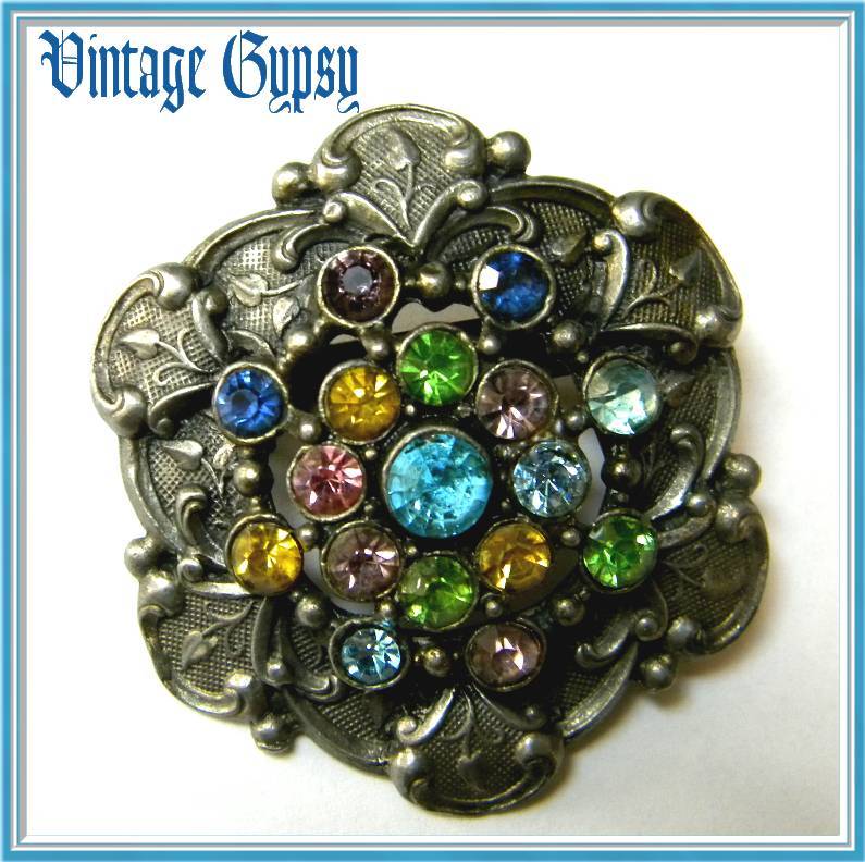Vintage Ornately Carved Pot Metal Brooch with Multi-Cored Rhinestones Vintage Ornately Carved Pot Metal Brooch with Multi-Cored Rhinestones