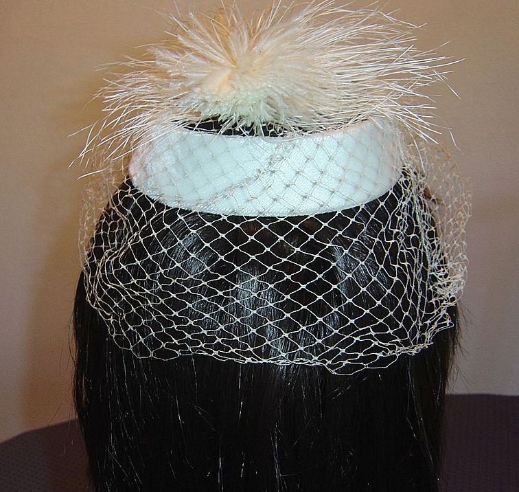 Elegant Off-White Topper with Ostrich Feather Accent. Elegant Off-White Topper with Ostrich Feather Accent.