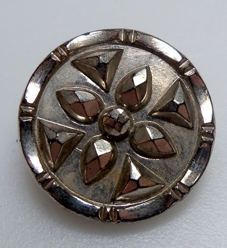Steel Button with a faceted floral open pattern Steel Button with a faceted floral open pattern